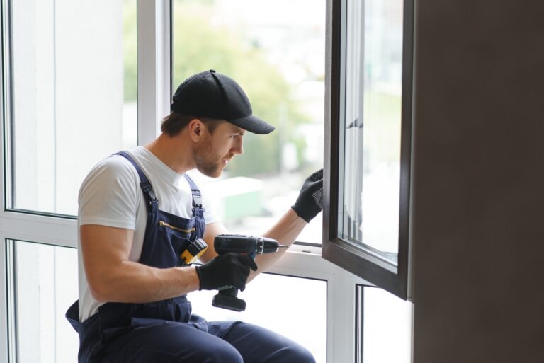 service man installing window with measure tape.